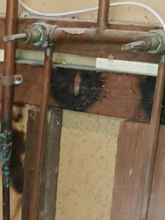 Close-up of copper pipework and tap fittings Troy is working on during a bathroom renovation