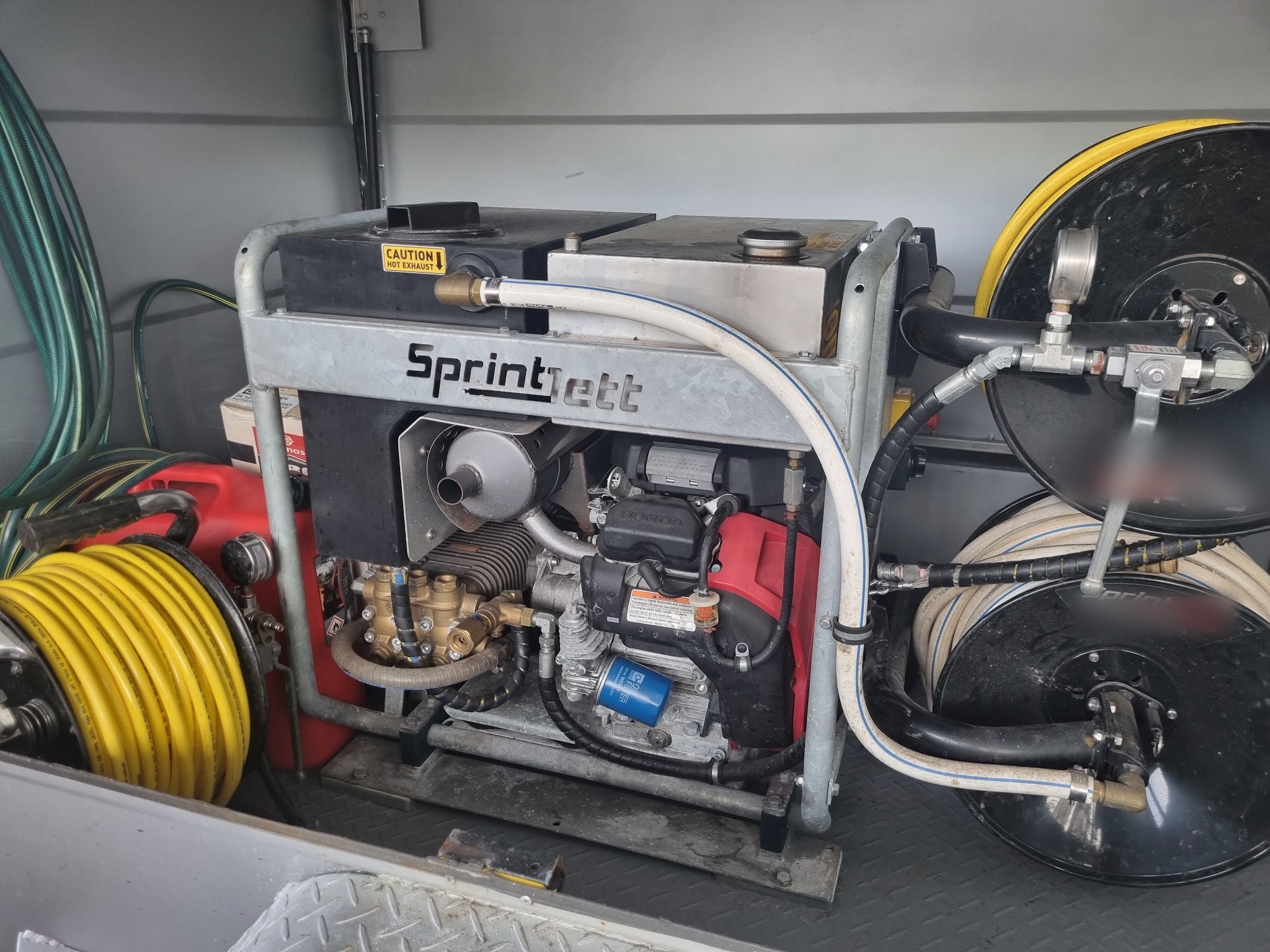 SprintJett high velocity water jetter and hose reels set up in the back of Troy's work vehicle